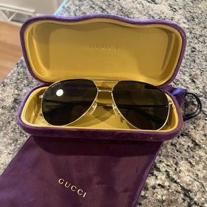Gucci black and gold sunglasses.